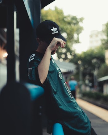 Man in Green Jersey T-shirt Wearing Black Adidas Baseball Cap