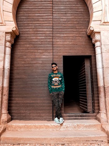 Man In Green Long-sleeved Top And Camouflage Pants