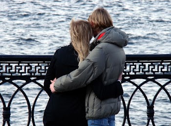 Man in Grey Bubble Jacket Beside Woman in Black Sweater