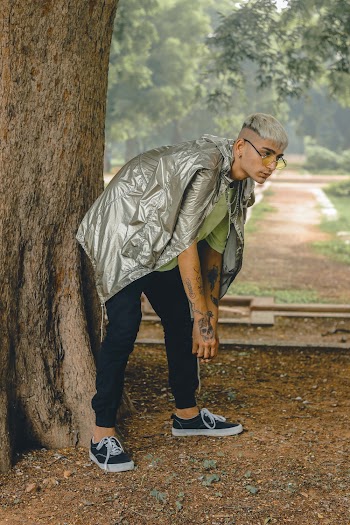 Man In Grey Jacket And Black Pants Beside Tree