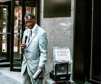 Man In Grey Suit Standing While Holding Microphone