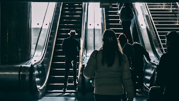Man in Hat at Escalator