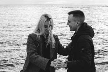Man in Hoodie Holding Hands with Woman