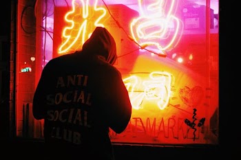 man in hoodie looking at the window