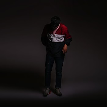 Man In Jacket Standing Looking Down