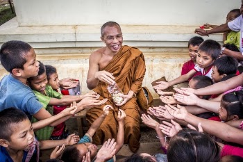 Man in Monk Dress Between Group of Children