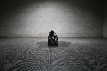 Man in Monk Suit Sitting