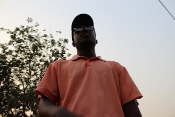 Man in Pink Polo Shirt Standing Near on Green Tree