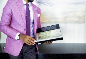 Man in Pink Suit Jacket Holding Book