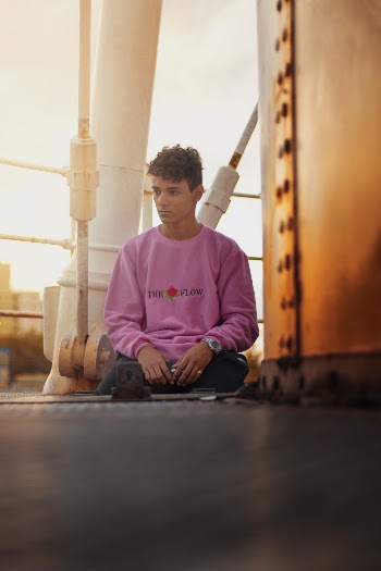 Man  in pink sweatshirt sitting