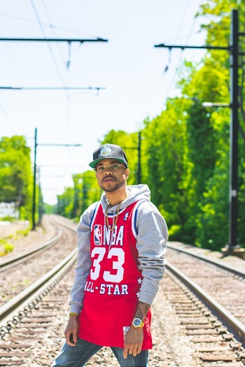 Man in Red and Gray Pullover Hoodie Standing on Train Tracks