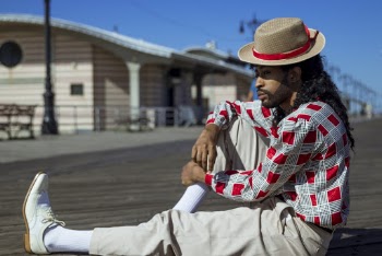 Man in Red and White Dress Shirt on Wooden Surface