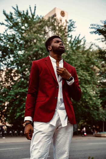 Man in Red Coat and White Bottoms Standing 