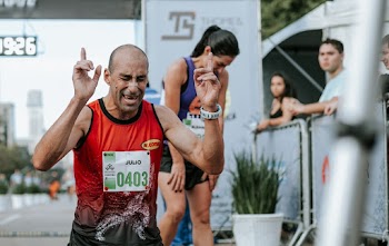 Man in Red Tank Top Winning A Marathon 