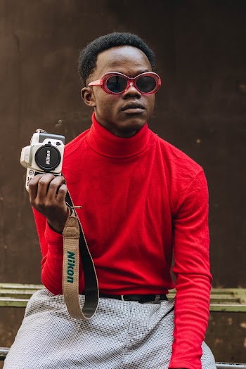 Man in Red Turtleneck Sweater Holding Dslr Camera