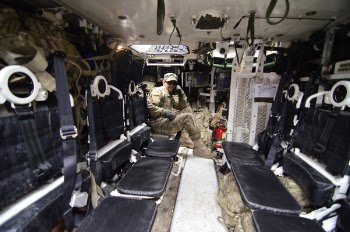 Man in Soldier Suit Sitting in Black Leather Seat