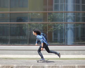 Man in Sport Shirt Riding Skateboard