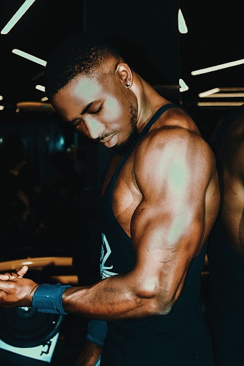 Man in Tank Top Holding Dumbbell