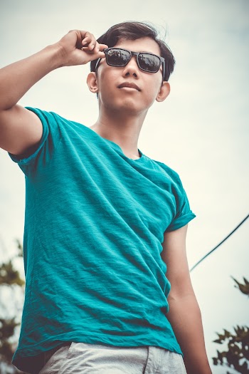 Man in Teal T-shirt Wearing Sunglasses