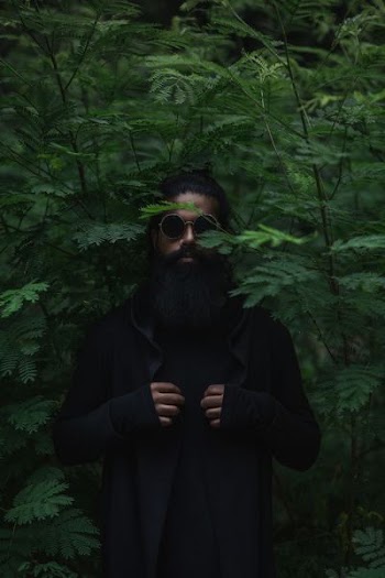 man in the middle of green plants at daytime