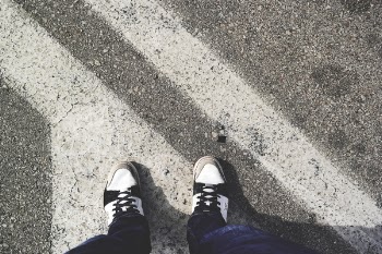 Man in White and Black Sneakers Standing Outdoor during Daytime