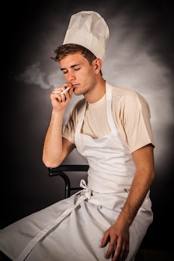 Man in White Apron Holding Cigarette Smoking