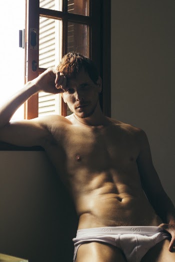Man in White Briefs Leaning Near Window Inside Room