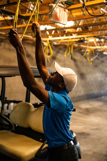 Man in White Cap and Blue Shirt Reaching A Yellow Rope