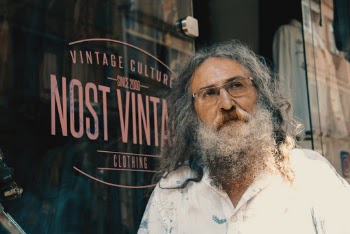 Man in White Collared Shirt Standing Beside Glass Window