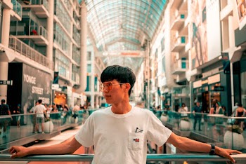Man in White Crew Neck T-shirt Standing in Mall