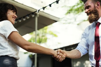 Man In White Dress Shirt And Maroon Neck Tie Shaking Hands With Girl In White Dress
