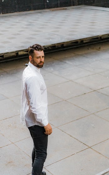 Man in White Dress Shirt Standing on Pavement