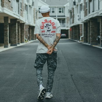 Man in White Garage T-shirt and Gray Camouflage Cargo Pants
