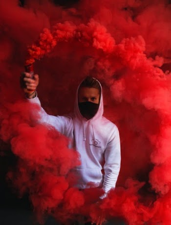 Man in White Hoodie Holding a Smoke Bomb · Free Stock Photo