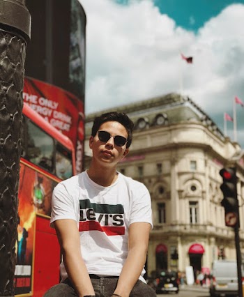 Man in White Levi's T Shirt in Sitting Position