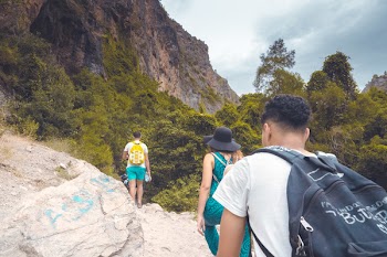 Man in White Shirt Carrying Black Backpack