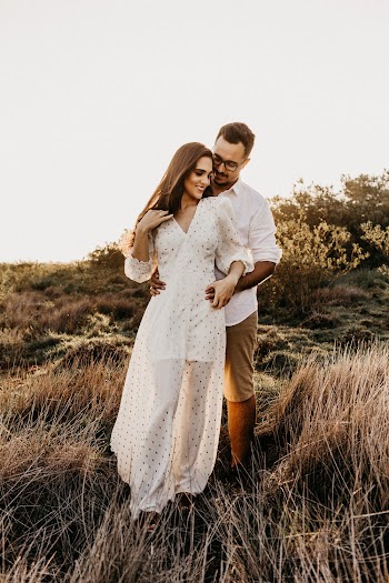 Man in White Shirt Hugging Woman in White Dress