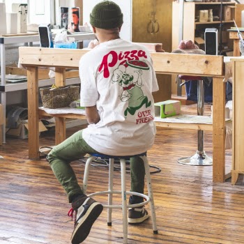 Man In White Shirt Sitting On Stool Inside Room