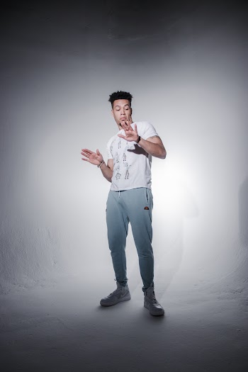 Man in White Shirt Standing and Raising His Hand