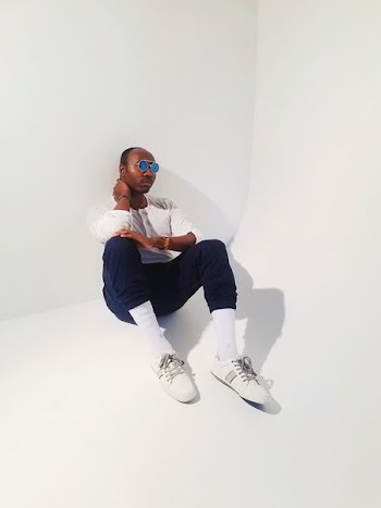 man in white sweater sitting