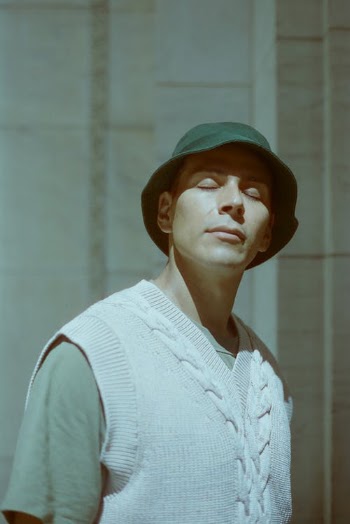 Man in White Sweater Vest Wearing a Green Bucket Hat · Free Stock Photo