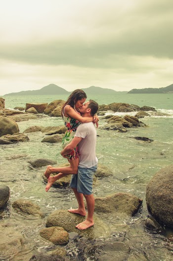 Man in White T-shirt Carrying Woman