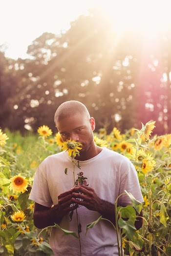 Man In White T-shirt Holding Sunflower
