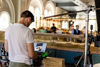 Man in White T-shirt Using Grey Laptop