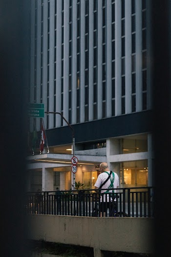 Man In White T Shirt Walking On Sidewalk