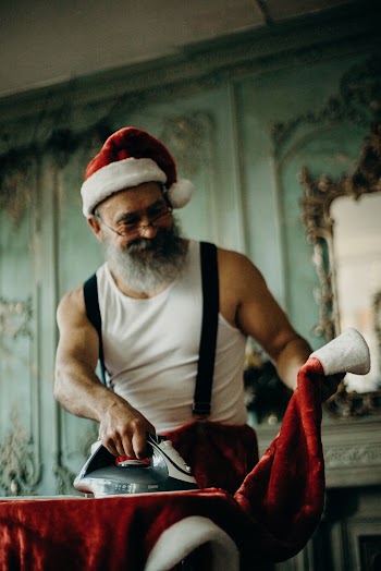 Man in White Tank Top Holding Clothes Iron