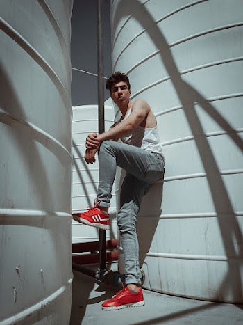 Man in White Tank Top Wearing Blue Low-top Sneakers