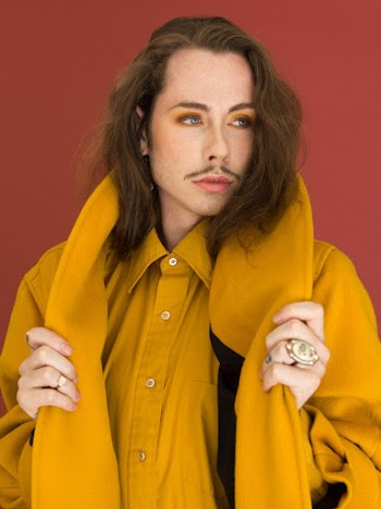 Man in Yellow Button-up Shirt Posing Beside Wall