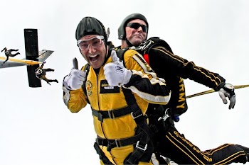 Man in Yellow Jumpsuit and Man in Black Jumpsuit Sky Diving