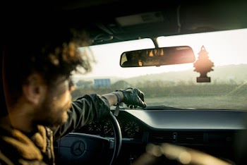 Man Inside A Car With Reflection On Rear View Mirror